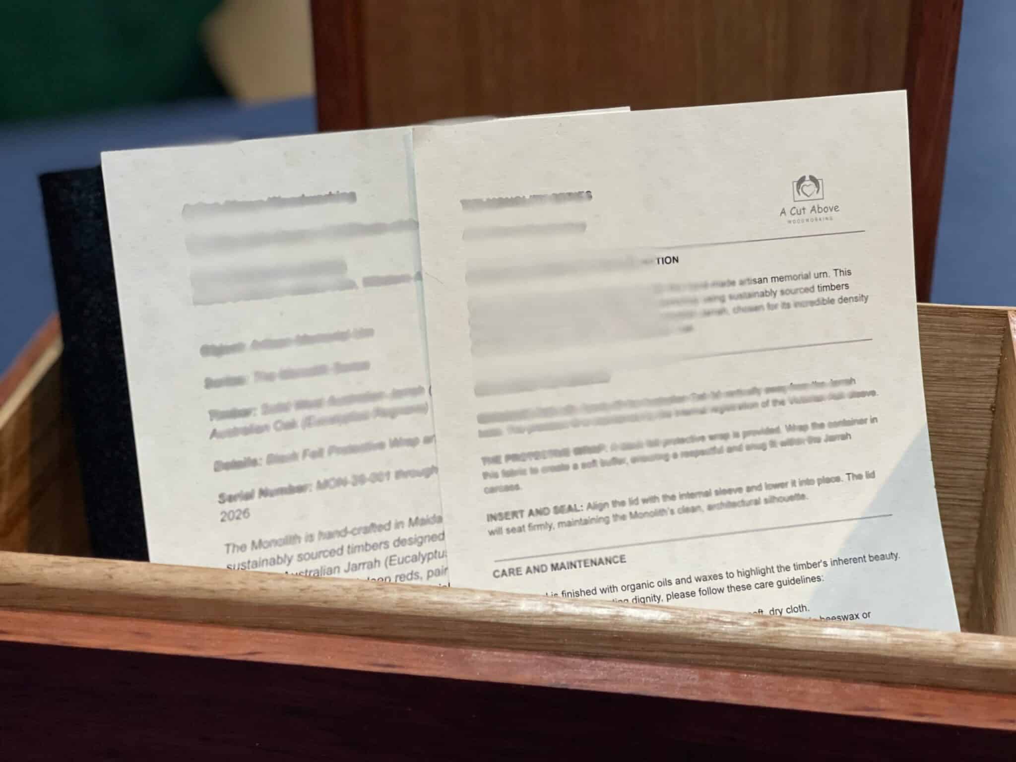 Handcrafted Monolith Jarrah Urn - Western Australian Solid Timber Memorial Vessel showing care card and certificate of authenticity.