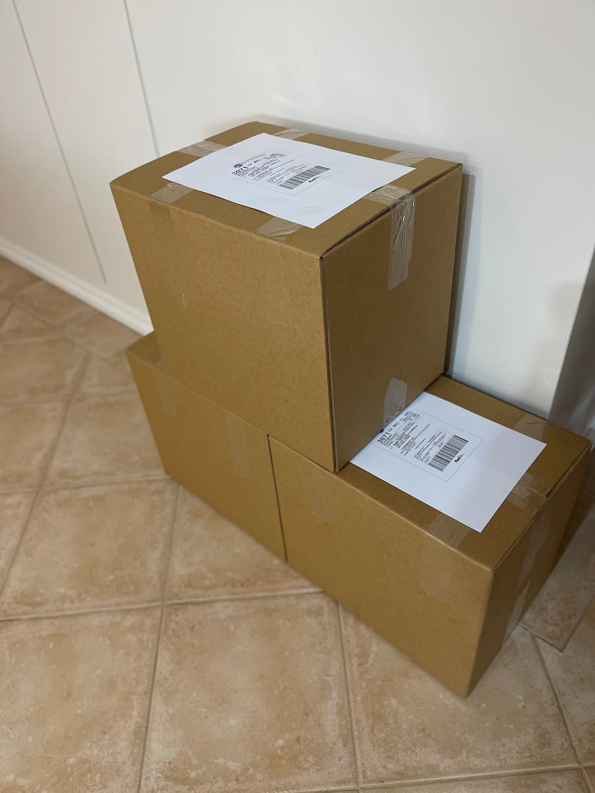 Sealed shipping cartons containing carefully packed handcrafted urns