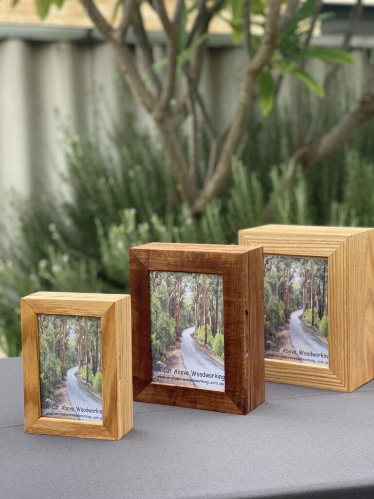 Side view of handcrafted Australian hardwood pet urns showing grain-wrapped corners and solid timber depth